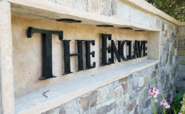 Enclave-Entry-Gate_Sign-Closeup—WEB